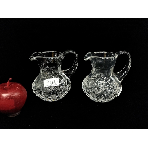 104 - A lovely pair of heavy crystal pitchers  and fluted edges. In very good condition.