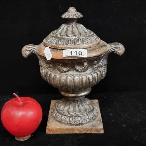 118 - A remarkably heavy cast iron planter, in the form of a classical Grecian lidded urn, on a rectangula... 