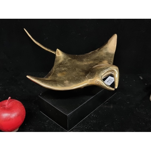 133 - A large polished brass sculpture of a manta ray on a matte black plinth. Features great detail. H15c... 