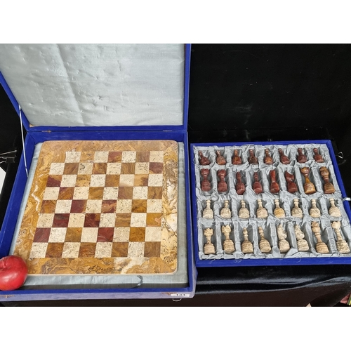 134 - Star Lot : A large fabulous complete marble chess set in shades of beige and brown. In a cobalt blue... 