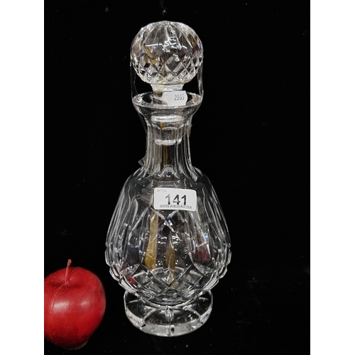 141 - A large heavy quality Waterford Crystal decanter in the Lismore pattern and stopper. In very good co... 