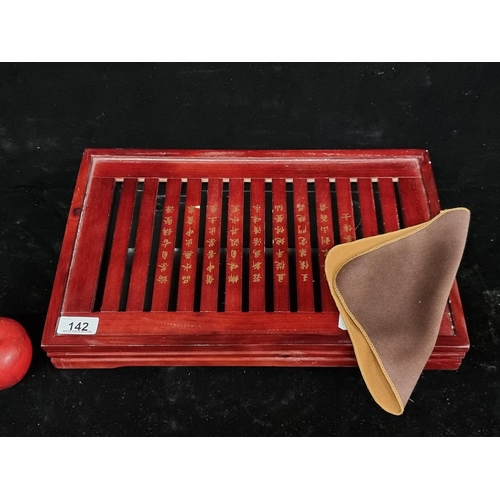 142 - An elegant Chinese, wooden tea tray with groves and a removable base for spillage. Features Chinese ... 