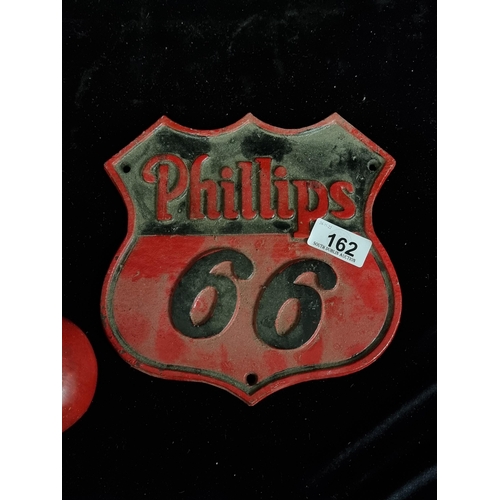 162 - A cast metal wall sign advertising Phillips 66 gasoline, a highway style sign in a red and black col... 