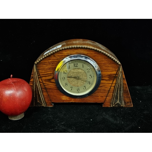 163 - A striking art deco mantle clock in an oak case with chrome bezel and geometric detail. Really hands... 