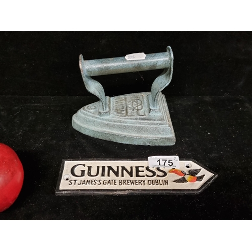 175 - Two cast metal objects including a wall sign for Guinness featuring the iconic Guinness toucan, with... 