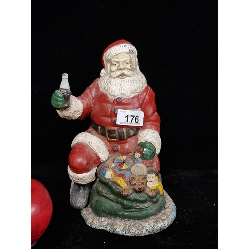 176 - A cast metal coin box in the form of a Coca-Cola Santa Claus figure, this jolly Santa figure is dres... 