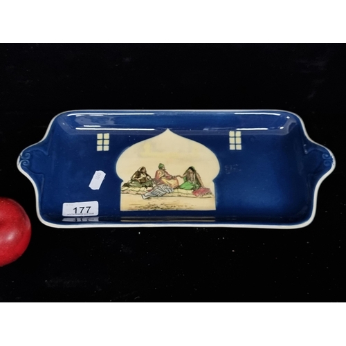 177 - A rare porcelain sandwich tray by Royal Doulton depicting an Indian marriage scene with a domed wind... 