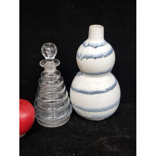 184 - A ceramic art pottery double gourd vase with alternating blue and white glazing. Accompanied by a Vi... 