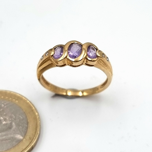 2 - A beautiful 9 carat Gold three stone set Amythyst and Diamond ring. This ring features dual Diamond ... 