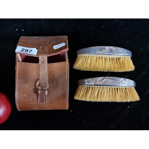 297 - A pair of clothes brushed with silver handles, hallmarked SJ London and dating to 1904. Comes with o... 