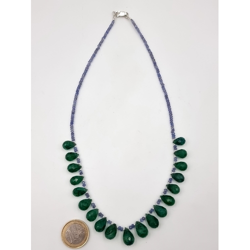 36 - Star lot : A very attractive single strand Tanzanite and Emerald drop necklace, of 140 carats and fe... 