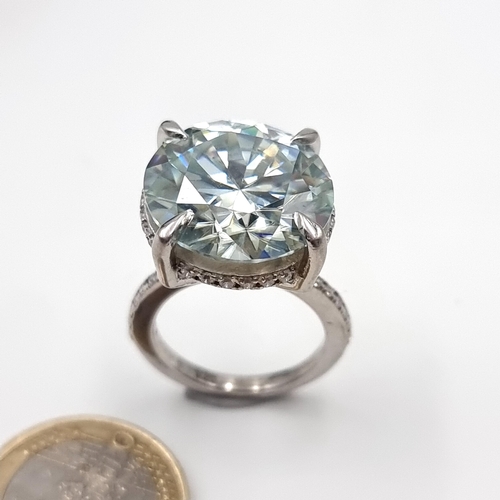 39 - A White Moissanite brilliant cut ring, of a large 19.8 carats. This example is set with White Signit... 