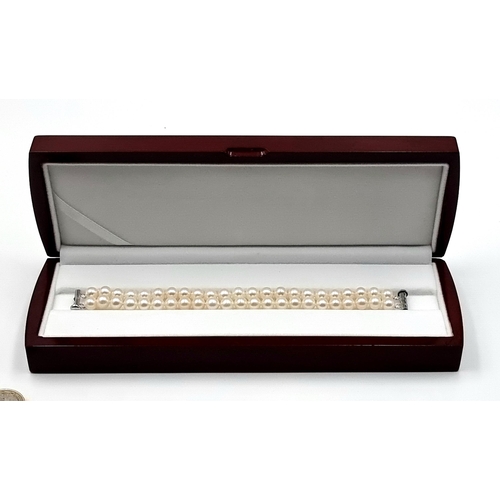 41 - A very handsome example of a newLegend new  two strand Lustre Pearl bracelet, with a sterling silver... 