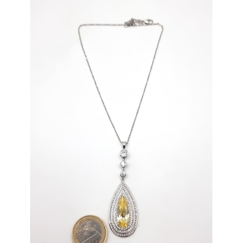 49 - An attractive sterling silver Tear drop Citrine stone pendant and chain. Set with a three band gem s... 
