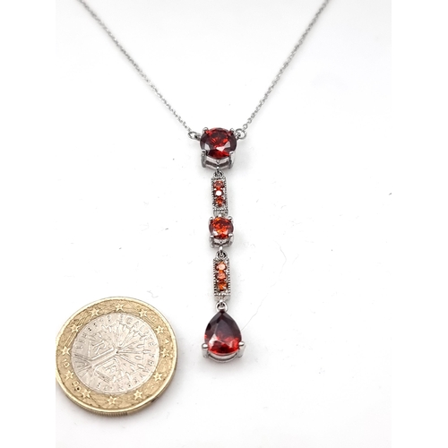 53 - A very pretty  sterling silver multi-set Garnet stone pendant and chain. Length: 40cm. Displayed in ... 
