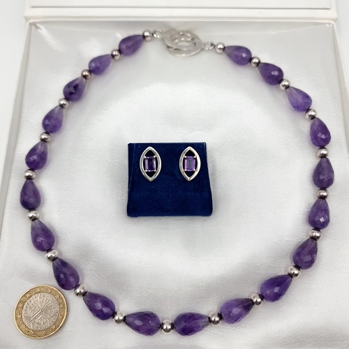 55 - A fine example of a twenty stone facet cut Amythyst necklace, with bead spaces and a sterling silver... 