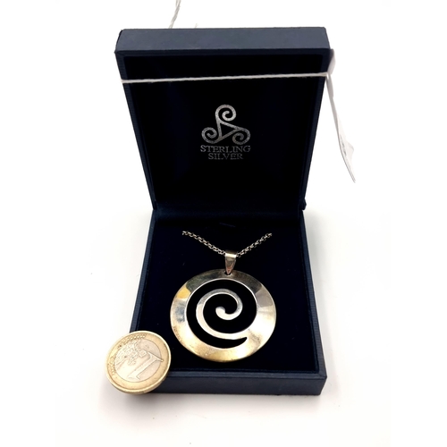 58 - A striking example of a Celtic sterling silver swirl pendant and chain. Length of chain: 60cm. Weigh... 