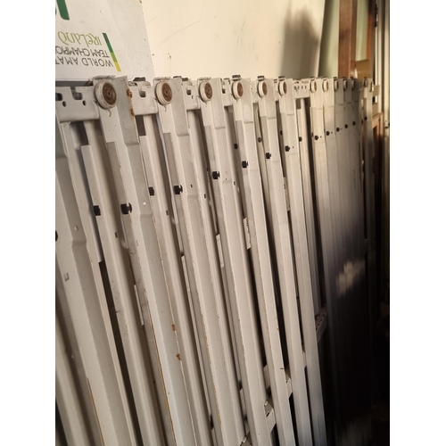 664 - Two white metal security grills measuring 122 cm x 204 cm.