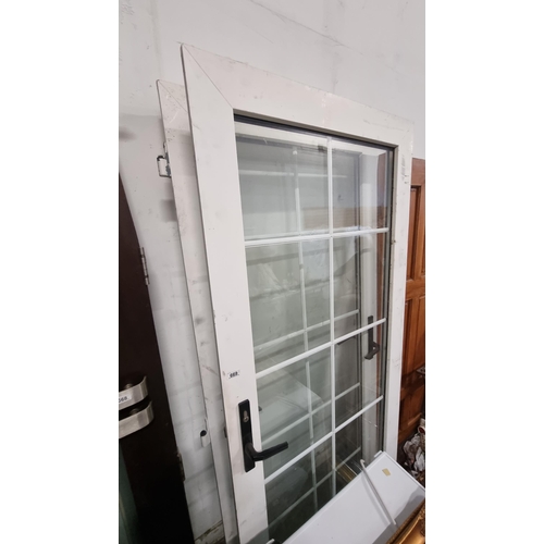 669 - A set of double-glazed PVC patio doors with lattice work on the glass. With key included. H204cm x W... 