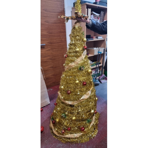 672 - Tall glittering gold tinsel spiral Christmas tree on a tripod base with matching gold and red bauble... 