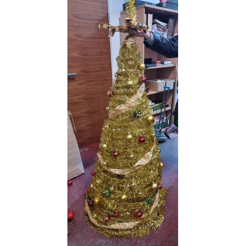 673 - Tall glittering gold tinsel spiral Christmas tree on a tripod base with matching gold and red bauble... 