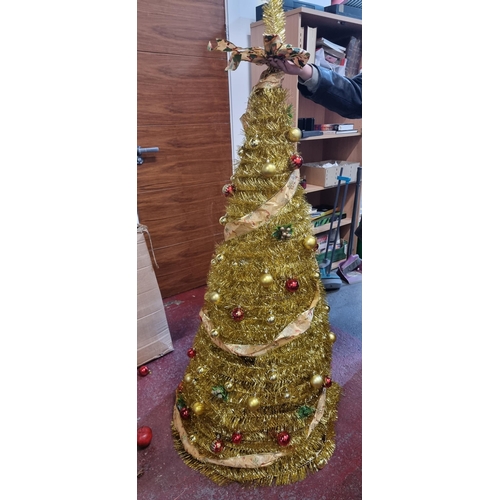 674 - Tall glittering gold tinsel spiral Christmas tree on a tripod base with matching gold and red bauble... 