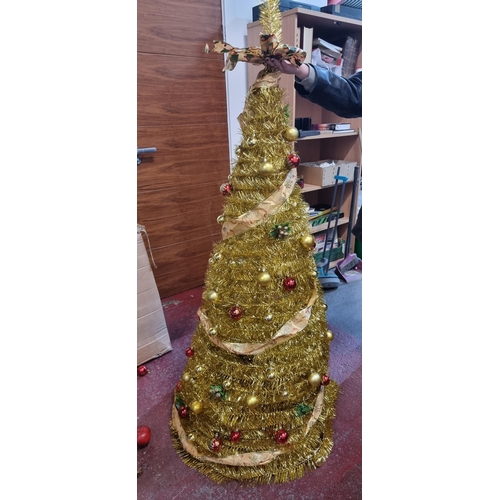 675 - Tall glittering gold tinsel spiral Christmas tree on a tripod base with matching gold and red bauble... 