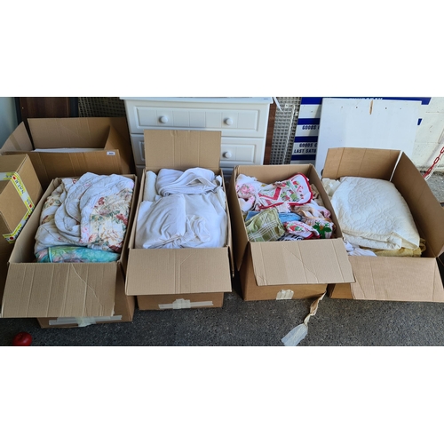 902 - Four boxes containing a large collection of bed linen, including some charming patchwork quilts, mat... 