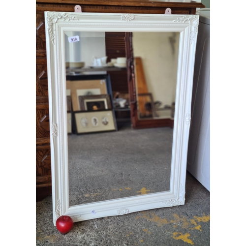 910 - A charming wall mirror with foliate carved detail and bevelled glass. In a white finish. H90cm x W64... 