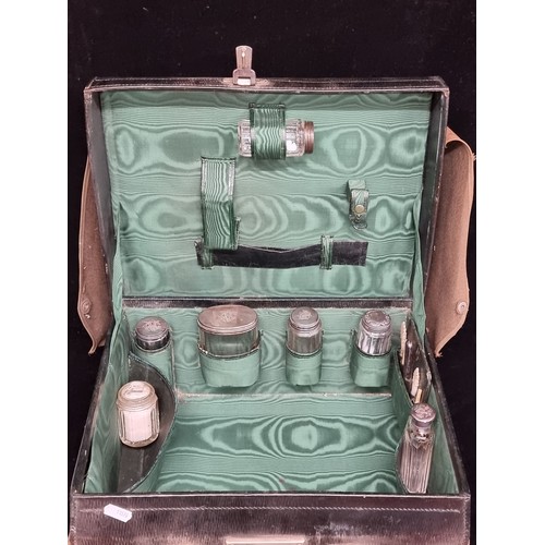 148 - Star lot : An exquisite early 20th century travel vanity case. Crafted from leather, with a heavy wo... 