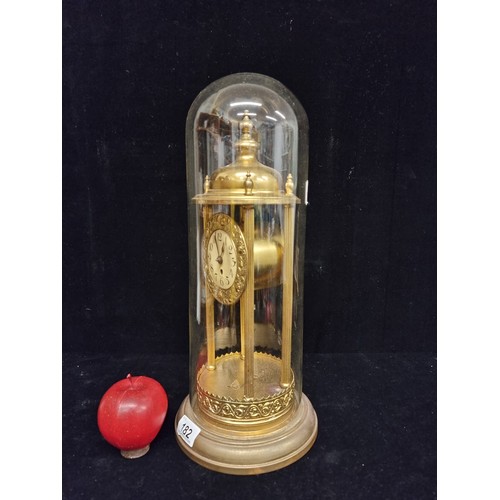 182 - Star lot : A large antique German very elegant, brass toned dome clock. Complete with glass dome, in... 