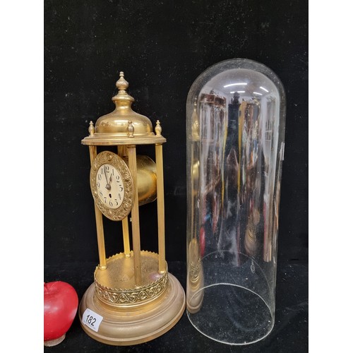 182 - Star lot : A large antique German very elegant, brass toned dome clock. Complete with glass dome, in... 