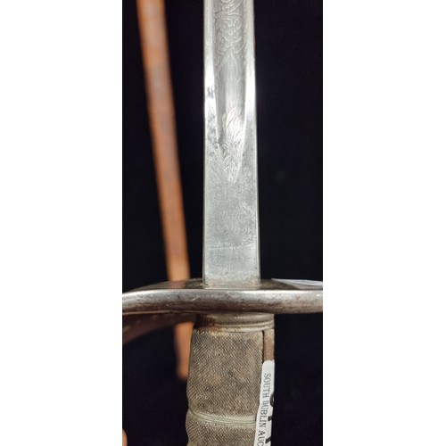 877 - A large impressive antique espada ropera sword with half basket hand guard with pierced design, inci... 