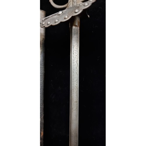 878 - A handsome antique clochemarde sword with metal hilt, incised baroque foliate ornament to blade and ... 