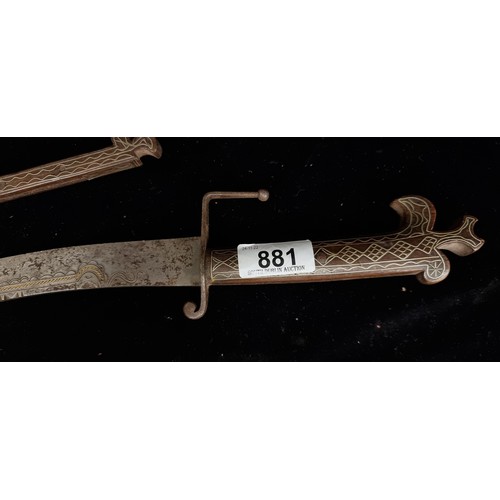 881 - An antique sabre with incised ornament inlaid with gold to the blade, wooden handle and scabbard, wi... 