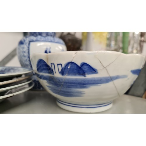 135 - Six 18th century Chinese, blue and white porcelain dishes, including four plates with staple repair,... 