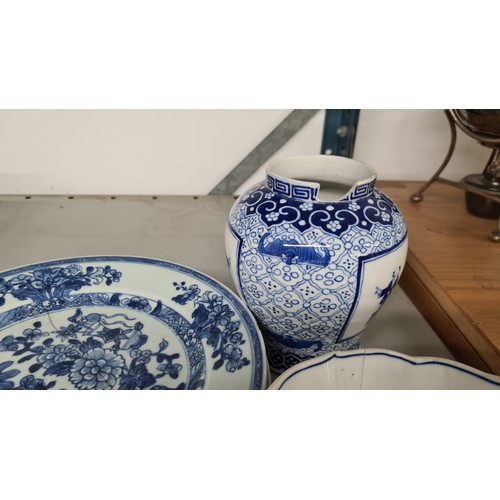 135 - Six 18th century Chinese, blue and white porcelain dishes, including four plates with staple repair,... 