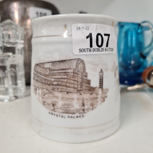 107 - An 1851 porcelain mug, featuring an illustration of the Crystal Palace, Great Exhibition  The mug is... 