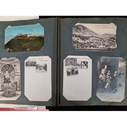 306 - A postcard album housing over 200 antique and vintage postcards and ephemera of religious interest, ... 