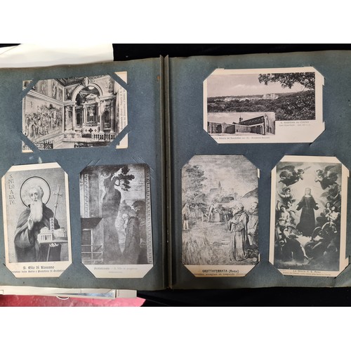 306 - A postcard album housing over 200 antique and vintage postcards and ephemera of religious interest, ... 