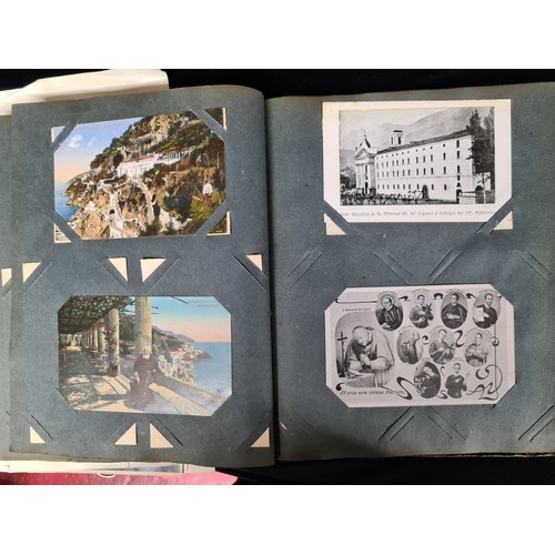 306 - A postcard album housing over 200 antique and vintage postcards and ephemera of religious interest, ... 