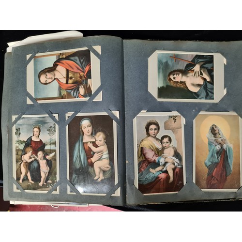 306 - A postcard album housing over 200 antique and vintage postcards and ephemera of religious interest, ... 