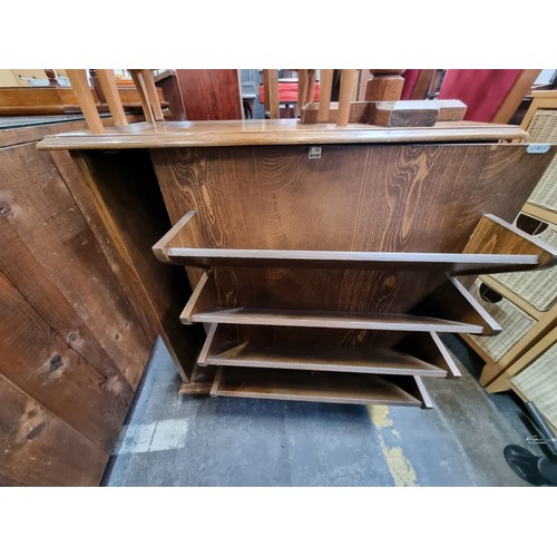 909 - An early twentieth century, oak shoe cabinet. Cleverly disguised as a chest of drawers with a false ... 