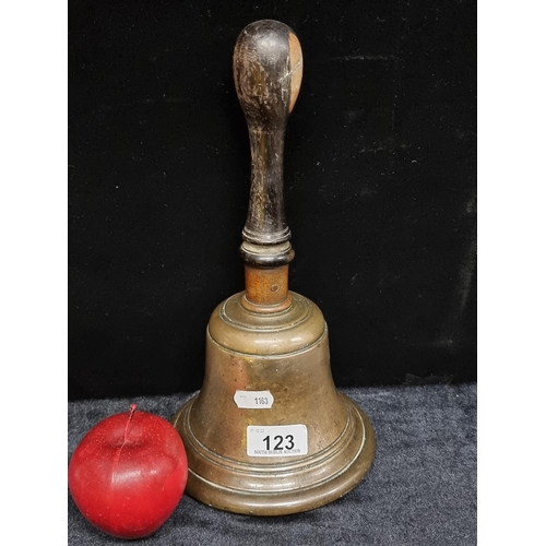 123 - A wonderful heavy, antique train station masters bell  bell. With a turned wooden handle, copper col... 