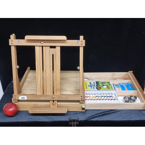 145 - A fully stocked artists easel and travel case. Complete with water colours sealed as well as paint b... 