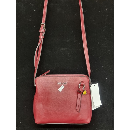 171 - A brand New Nine West Selina mini over the shoulder handbag in a warm maroon Claret colour with orig... 