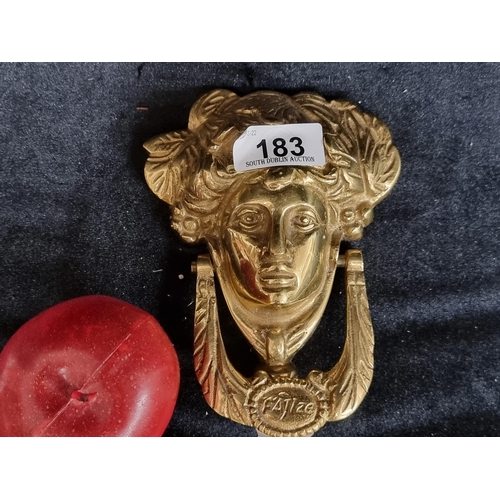 183 - A heavy solid brass door knocker in the Georgian style featuring the iconic face of Anna Livia. The ... 