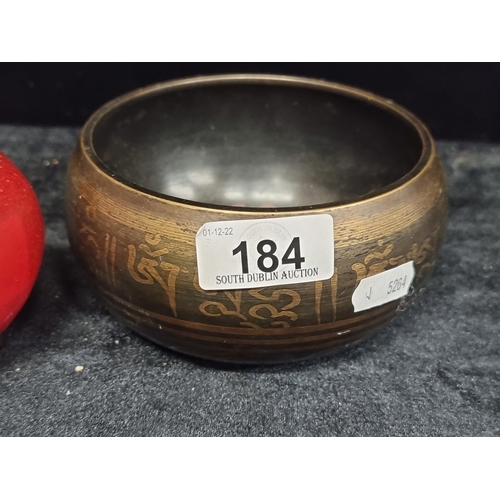 184 - A vintage bronze Tibetan Buddhist singing bowl. With a wheel of five Buddhas in relief on interior a... 