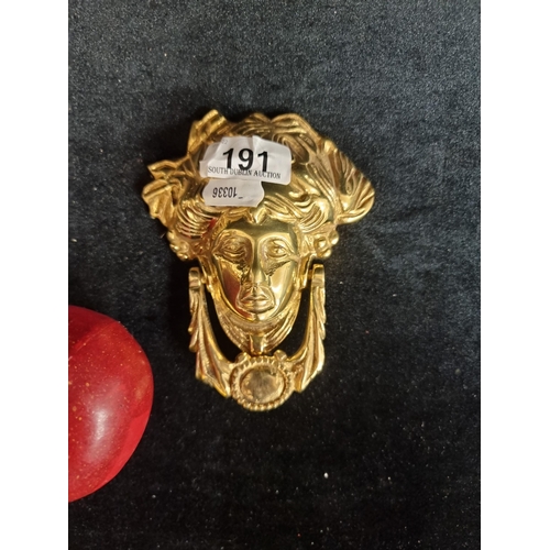 191 - A heavy solid brass door knocker in the Georgian style featuring the iconic face of Anna Livia. The ... 