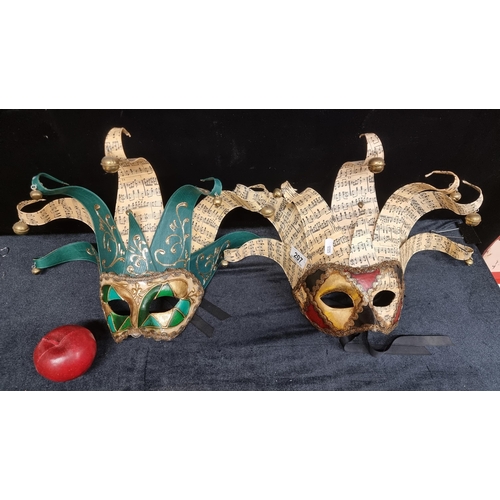 207 - A pair of beautiful large Venetian masks with crowns made of sheet music adorned with bells, featuri... 